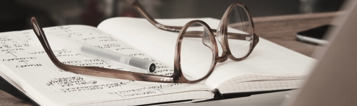 Pair of Glasses on a Notebook