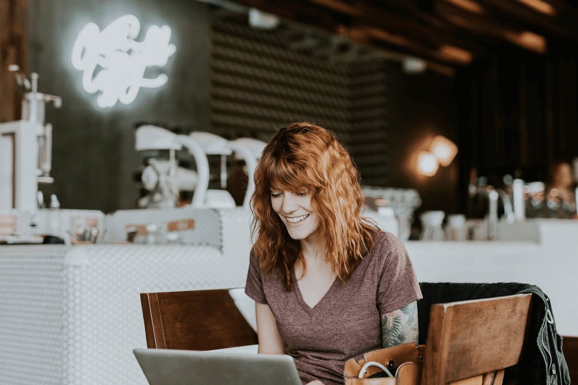 Woman studying online at a table with laptop